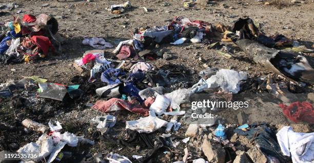 Graphic content / Personal belongings and debris are pictured scattered on the ground after a Ukrainian plane carrying 176 passengers crashed near...