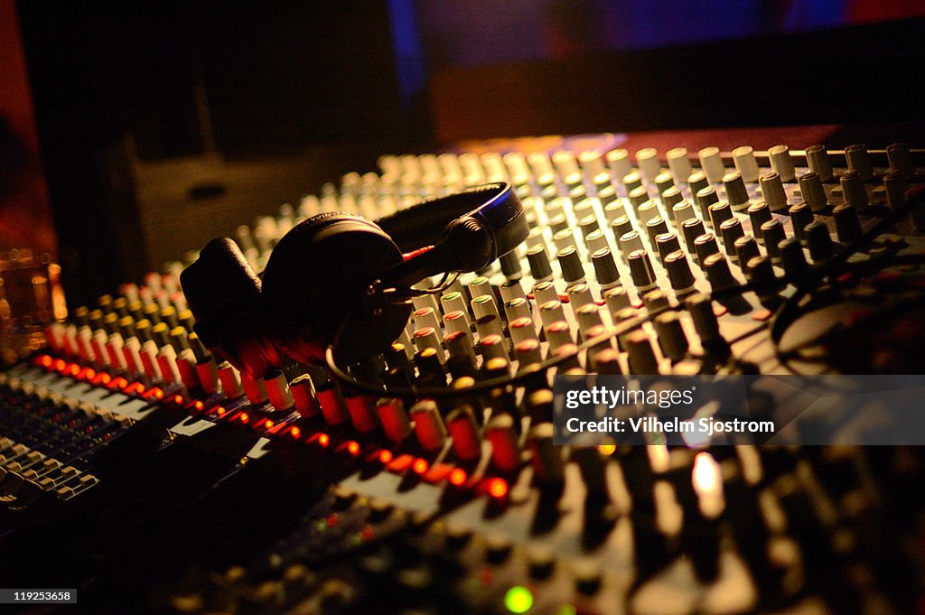 Headphones lay on mixing desk