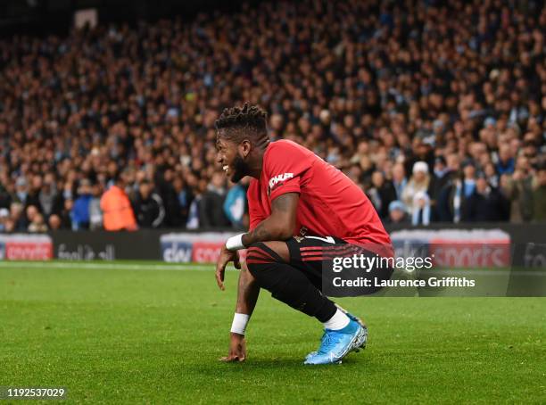 Fred of Manchester United reacts after being hit by a lighter thrown from the crowd during the Premier League match between Manchester City and...