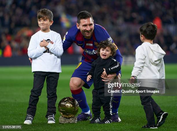 Lionel Messi of FC Barcelona poses with his sixth Ballon d'Or trophy and his children Ciro Messi Roccuzzo, Thiago Messi Roccuzzo and Mateo Messi...
