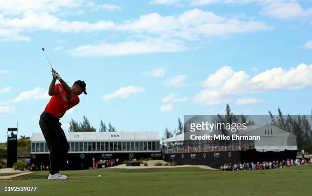 Tiger Woods of the United States hits is approach shot on the 18th hole during the final round of the Hero World Challenge at Albany on December 07,...