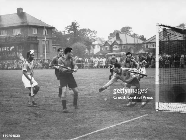 The Indian team attacks the Spanish goalmouth during preliminary field hockey matches at Chiswick, during the Olympic Games, London, 6th August 1948.
