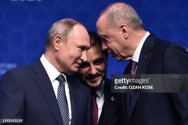 Russian President Vladimir Putin and Turkish President Recep Tayyip Erdogan speak as they attend an inauguration ceremony of a new gas pipeline...