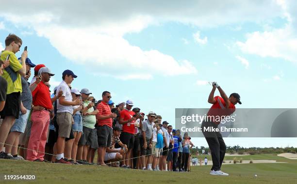 Tiger Woods of the United States hits is approach shot on the 11th hole during the final round of the Hero World Challenge at Albany on December 07,...