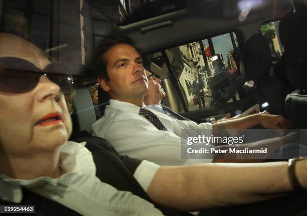 Lachlan Murdoch sits next to his father Rupert Murdoch, Chief Executive of News Corporation as they leave their home with an un-named personal...