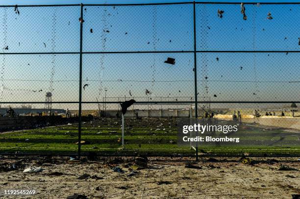 Debris from the wreckage of a Boeing Co. 737-800 aircraft, operated by Ukraine International Airlines, which crashed shortly after takeoff covers the...