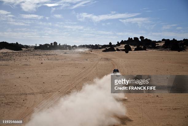 Toyota's Qatari driver Nasser Al-Attiyah of Qatar and his French co-driver Mathieu Baumel compete during the Stage 4 of the Dakar 2020 between Neom...