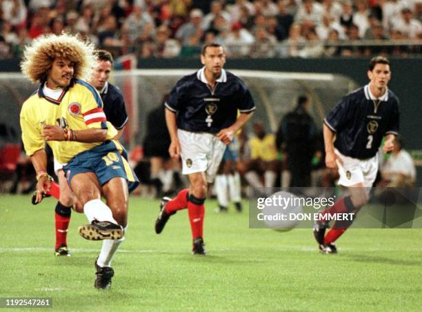 Colombia's Carlos Valderrama knocks a free kick to score against Scotland goalkeeper Neil Sullivan 23 May in East Rutherford, NJ. The goal gave...