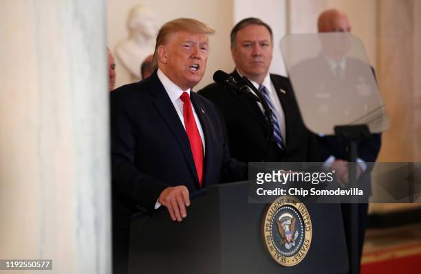 President Donald Trump speaks from the White House as Secretary of State Mike Pompeo listens on January 08, 2020 in Washington, DC. During his...