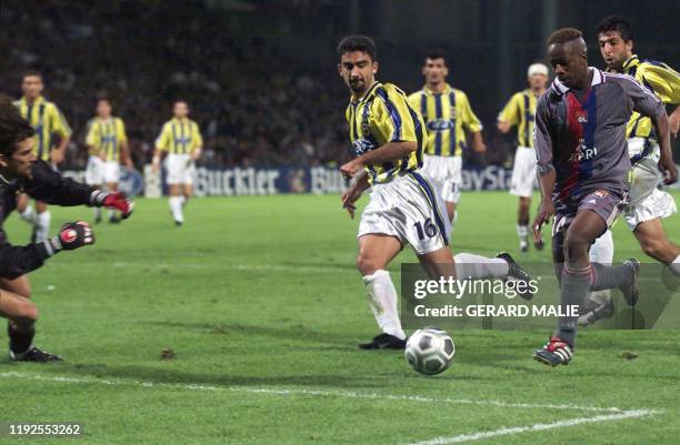 L'attaquant lyonnais Sidney Govou s'apprête à marquer pour son équipe, malgré les Turcs Umit et le gardien Rustu, le 17 octobre 2001 au stade de...