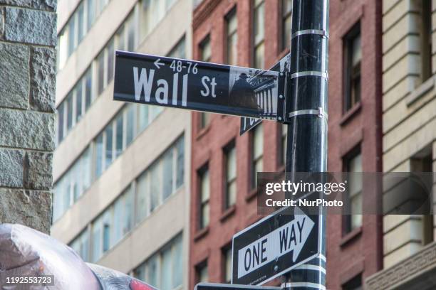 Wall Street sign inscription as seen on various buildings, Wall St address, Downtown in lower Manhattan is a significant road and area district for...