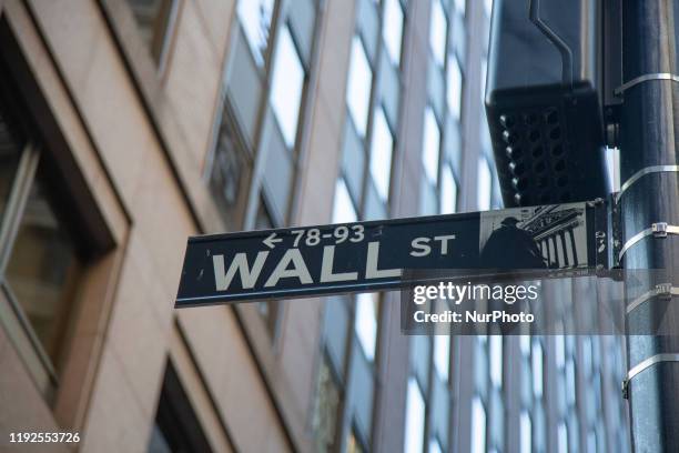 Wall Street sign inscription as seen on various buildings, Wall St address, Downtown in lower Manhattan is a significant road and area district for...