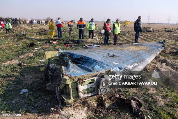 Rescue teams are seen on January 8, 2020 at the scene of a Ukrainian airliner that crashed shortly after take-off near Imam Khomeini airport in the...