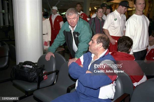 Coca-Cola Classic: Michigan State head coach George Perles and Wisconsin head coach Barry Alvarez in airport during refuel en route to game at Tokyo...