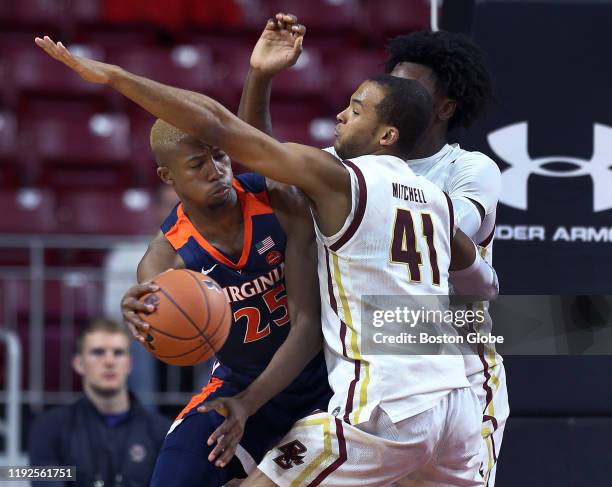 Boston College Eagles' Steffon Mitchell and CJ Felder defend against Virginia's Mamadi Diakite . The Boston College Eagles men's basketball team...