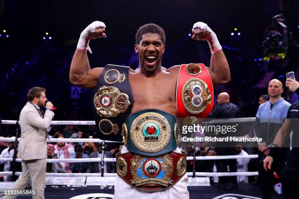 Anthony Joshua poses for a photo with the IBF, WBA, WBO & IBO World Heavyweight Title belts after the IBF, WBA, WBO & IBO World Heavyweight Title...
