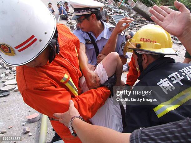 Emergency services attend the scene of a bus accident after it plunged from the collapsed Wuyishan Gongguan Bridge on July 14, 2011 in Wuyishan,...