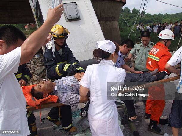 Emergency services attend the scene of a bus accident after it plunged from the collapsed Wuyishan Gongguan Bridge on July 14, 2011 in Wuyishan,...