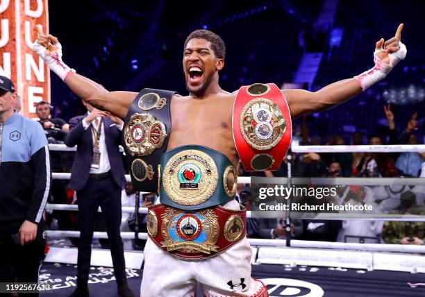 Anthony Joshua poses for a photo with the IBF, WBA, WBO & IBO World Heavyweight Title belts after the IBF, WBA, WBO & IBO World Heavyweight Title...