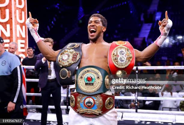 Anthony Joshua poses for a photo with the IBF, WBA, WBO & IBO World Heavyweight Title belts after the IBF, WBA, WBO & IBO World Heavyweight Title...