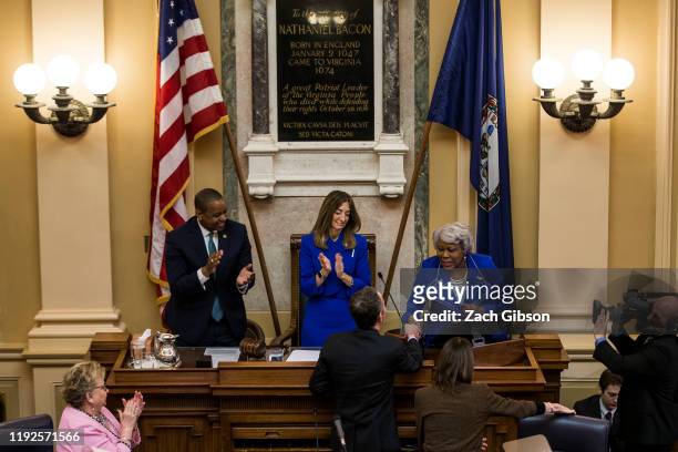 Senate President Pro Tempore Louise Lucas shakes hands with Gov. Ralph Northam as Lt. Gov. Justin Fairfax and House of Delegates Speaker Eileen...