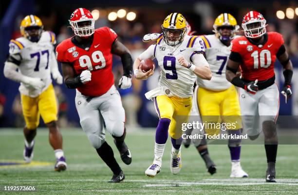 Joe Burrow of the LSU Tigers runs with the ball in the first half against the Georgia Bulldogs during the SEC Championship game at Mercedes-Benz...