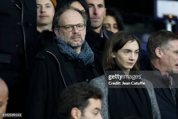 Denis Podalydes and his partner Leslie Menu attend the French League Cup quarter final between Paris Saint-Germain and AS Saint-Etienne at Parc des...