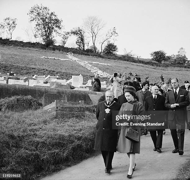 Queen Elizabeth II and Prince Philip visit the coalmining village of Aberfan in South Wales, eight days after the disaster in which 116 children and...