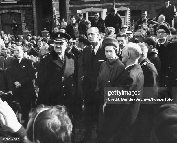 Queen Elizabeth II and Prince Philip visit the coalmining village of Aberfan in South Wales, eight days after the disaster in which 116 children and...