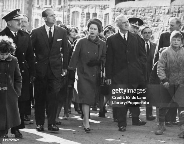 Queen Elizabeth II and Prince Philip visit the coalmining village of Aberfan in South Wales, eight days after the disaster in which 116 children and...