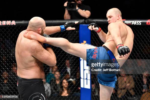 Stefan Struve of Netherlands kicks Ben Rothwell in their heavyweight bout during the UFC Fight Night event at Capital One Arena on December 07, 2019...