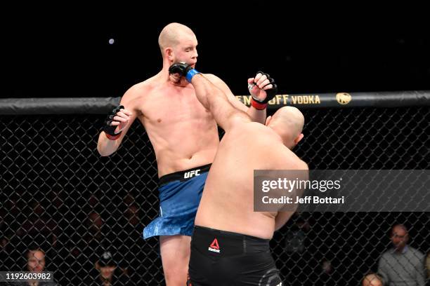 Ben Rothwell punches Stefan Struve of Netherlands in their heavyweight bout during the UFC Fight Night event at Capital One Arena on December 07,...