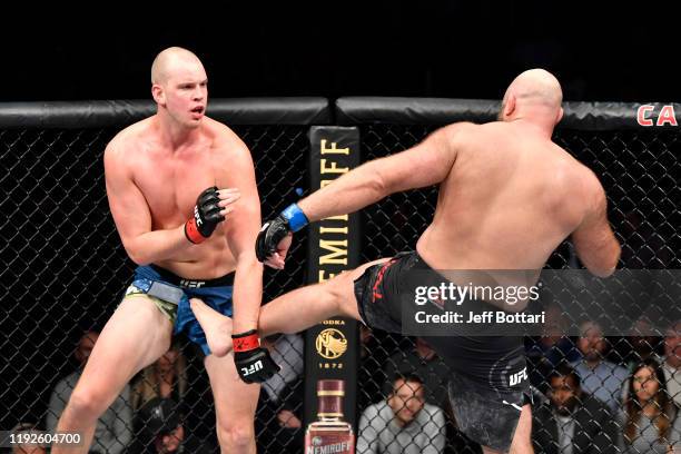 Ben Rothwell accidentally kicks Stefan Struve of Netherlands in the groin in their heavyweight bout during the UFC Fight Night event at Capital One...