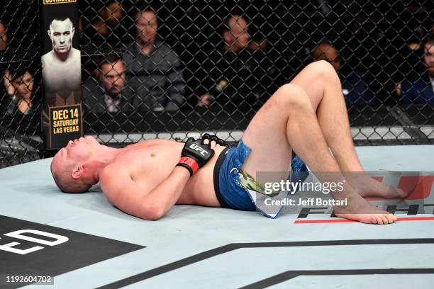 Stefan Struve of Netherlands reacts after being kicked in the groin by Ben Rothwell in their heavyweight bout during the UFC Fight Night event at...