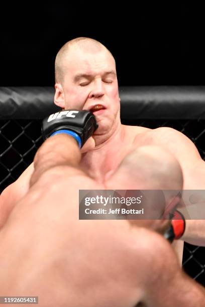 Ben Rothwell punches Stefan Struve of Netherlands in their heavyweight bout during the UFC Fight Night event at Capital One Arena on December 07,...