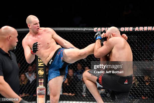 Stefan Struve of Netherlands kicks Ben Rothwell in their heavyweight bout during the UFC Fight Night event at Capital One Arena on December 07, 2019...