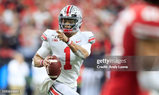 Justin Fields of the Ohio State Buckeyes runs with the ball in the BIG Ten Football Championship Game against the Wisconsin Badgers at Lucas Oil...