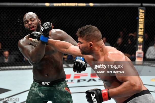 Alistair Overeem of Netherlands punches Jairzinho Rozenstruik of Suriname in their heavyweight bout during the UFC Fight Night event at Capital One...