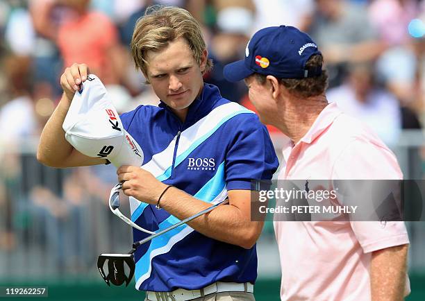 English golfer Tom Lewis talks to US golfer Tom Watson on the 18th green, on the second day of the 140th British Open Golf championship at Royal St...