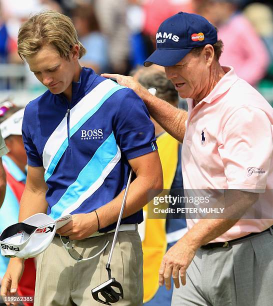 Golfer Tom Watson puts his hand on the shoulder of English golfer Tom Lewis on the 18th green, on the second day of the 140th British Open Golf...