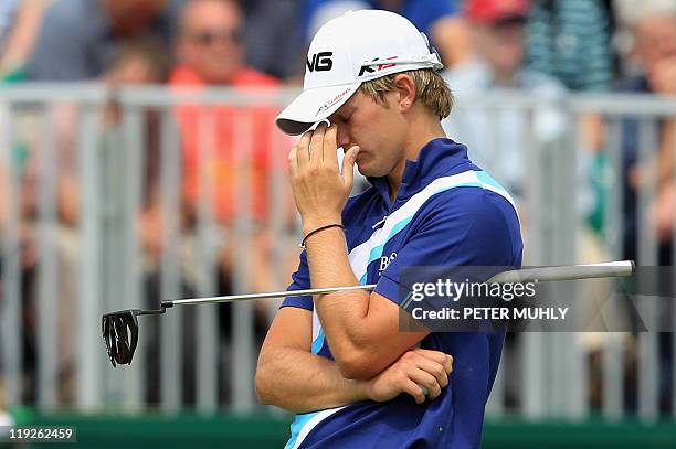 English golfer Tom Lewis gestures on the 18th green, on the second day of the 140th British Open Golf championship at Royal St George's in Sandwich,...