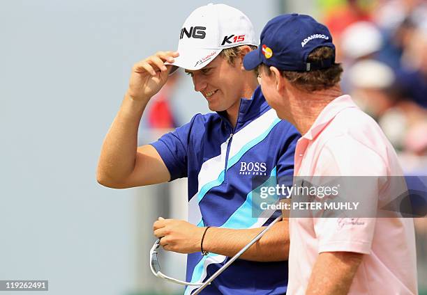 English golfer Tom Lewis talks to US golfer Tom Watson on the 18th green, on the second day of the 140th British Open Golf championship at Royal St...