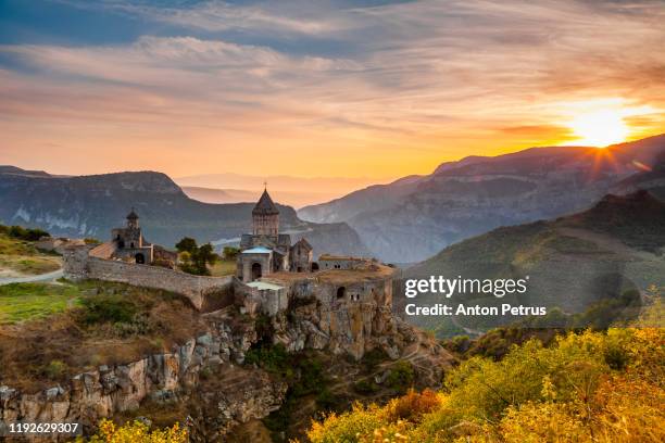 tatev monastery at sunrise in the mountains. tatev, armenia - armenia stockfoto's en -beelden