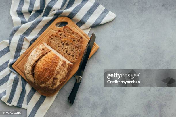 freshly baked bread on wooden table - chopping board from above stock pictures, royalty-free photos & images