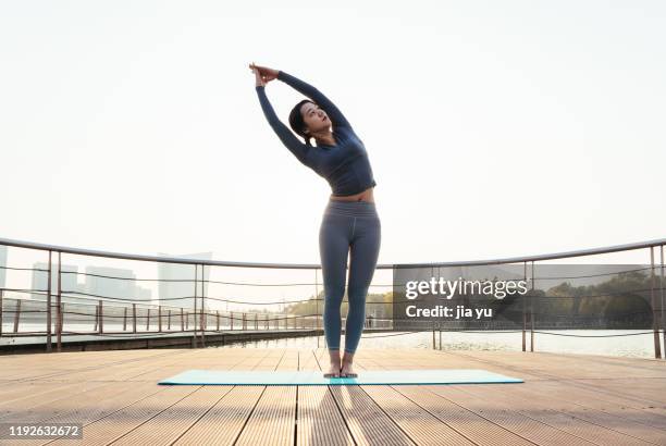 a young woman is practicing yoga. - suzhou china fotografías e imágenes de stock