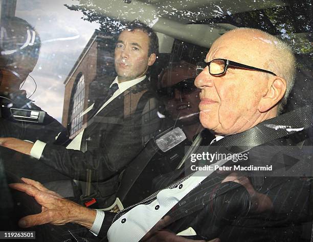 News Corp. Chairman Rupert Murdoch rides with News International General Manager Will Lewis as they leave headquarters on July 15, 2011 in London,...