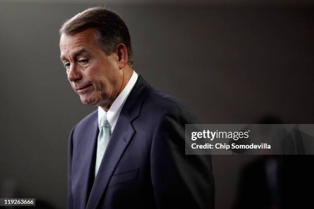 Speaker of the House John Boehner answers reporters' questions during a news conference following a House GOP caucus meeting at the U.S. Capitol July...