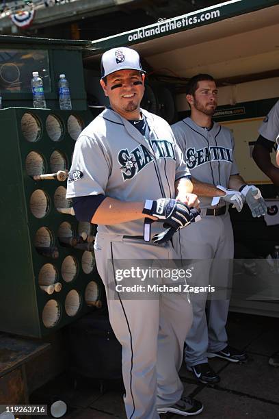 Jack Cust of the Seattle Mariners watches the field from the dugout during the game against the Oakland Athletics at the Oakland-Alameda County...