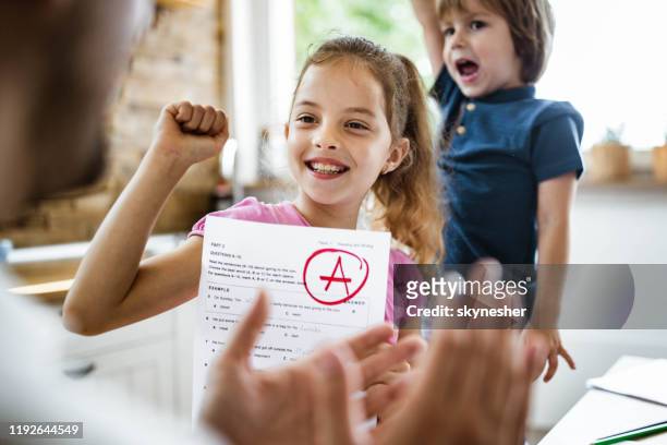 yay daddy, i've got an a on my exam! - child report card stock pictures, royalty-free photos & images