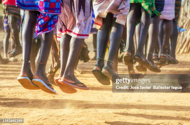 the tradition of jumping and singing to show women who is the warrior who jumps the most with the intendion to be chosen as a husband. omo valley tribes ceremony - dancing feet stock pictures, royalty-free photos & images